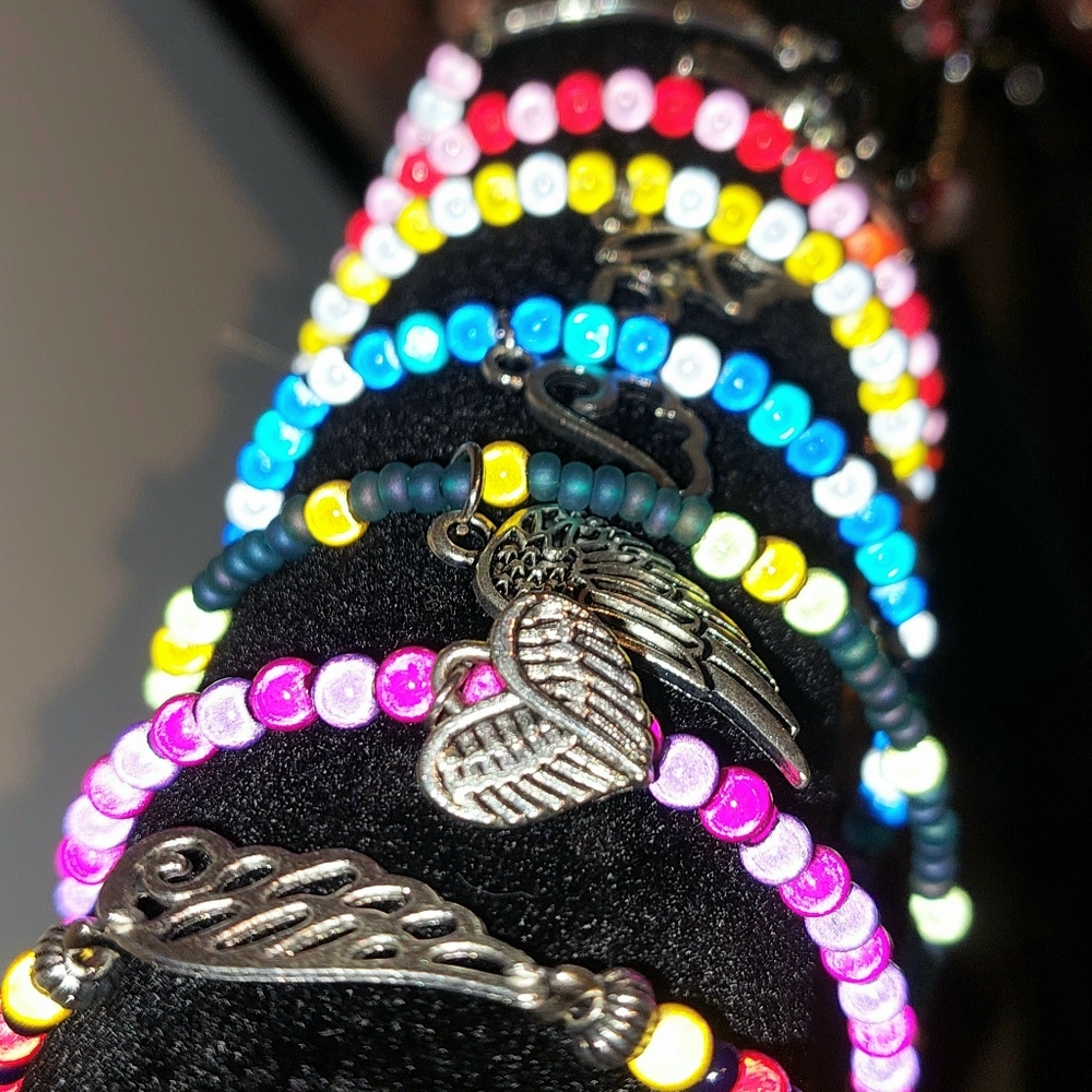 Stack of 6 colorful bracelets with angel wings